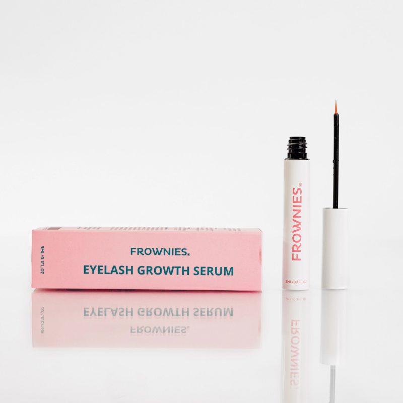 Frownies Eyelash Growth Serum shown outside its package, prominently featuring the pink packaging with Frownies branding.