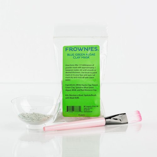 Frownies blue green algae clay mask shown pictured on a clean white background. The cup and brush used for this product are also shown pictured