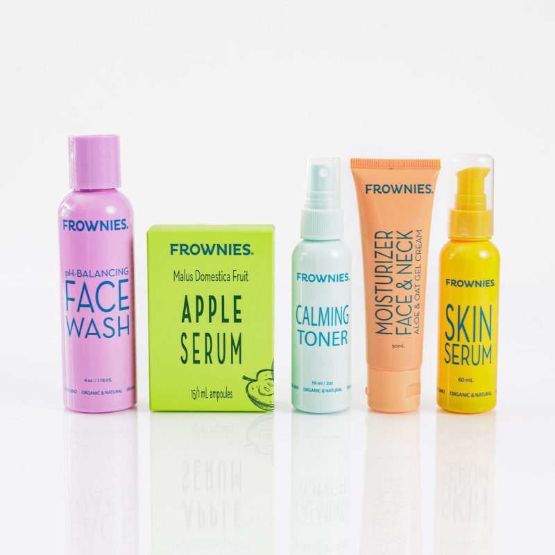 Group of Frownies products - face wash, apple serum, calming toner, moisturizer for face and neck, and skin serum